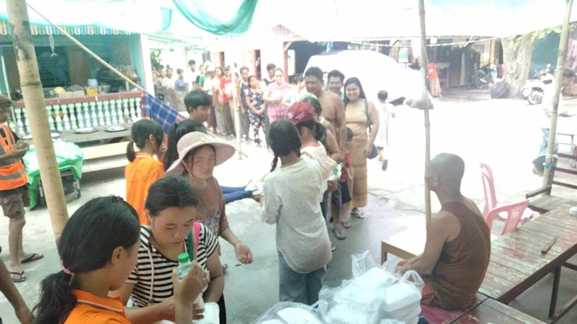 Volunteers distributing aid in a rural village